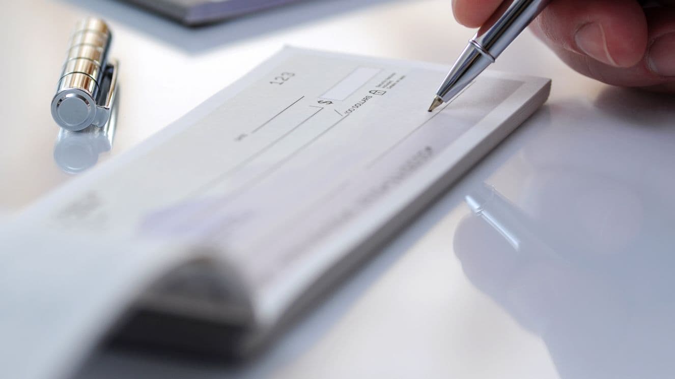Stock image - filling out a paper check.